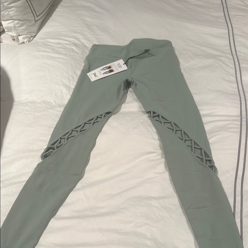 ALO Yoga Green Leggings with Intricate Cutout Design